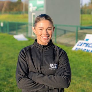 Benchmark coach smiling on the pitch