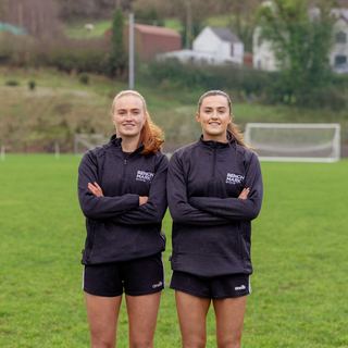 Two Benchmark coaches on a GAA pitch